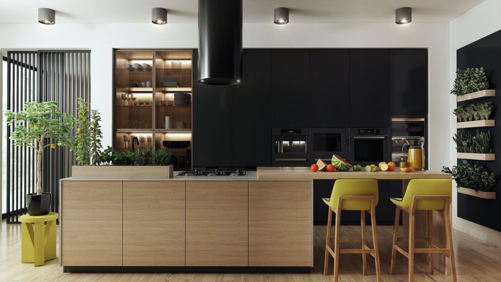 A kitchen with black cabinetry, a wood island and a bank of built-in appliances including a wine cabinet