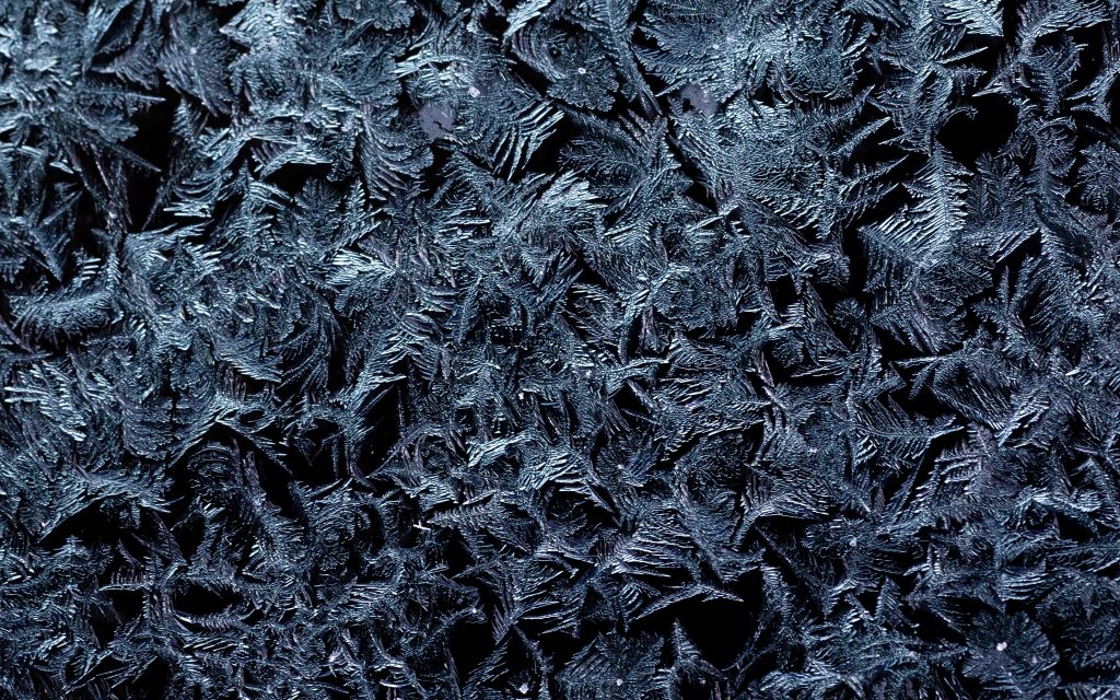 Close-up of frost crystals forming on a cold surface