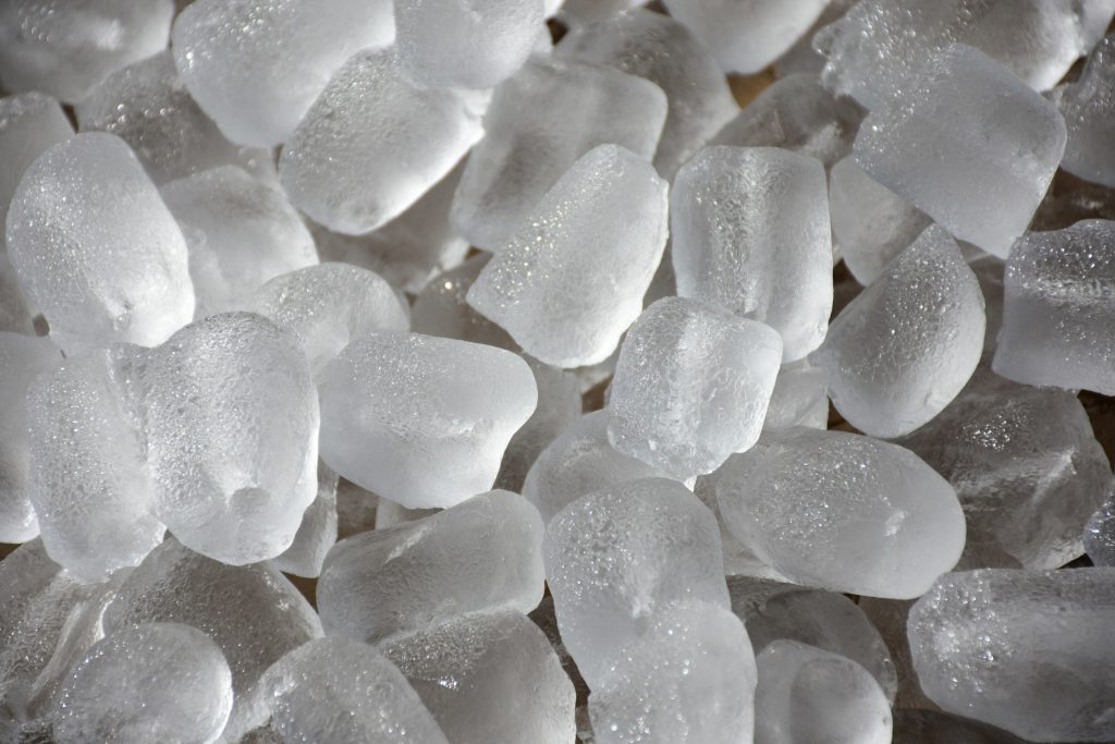 A heap of crescent ice cubes fresh from the maker