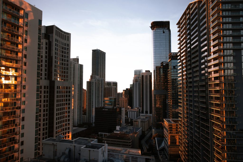 High-rise towers packed close together, lit gold at the end of the day