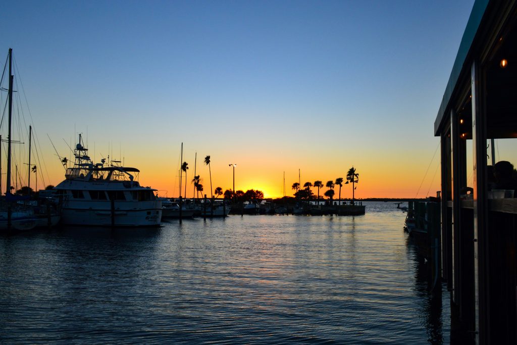 Boats and docks at sunset on flat water