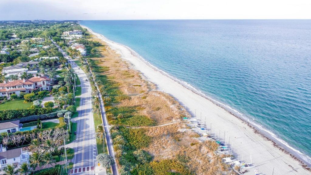 The coast road between oceanfront houses and the dunes, from the air