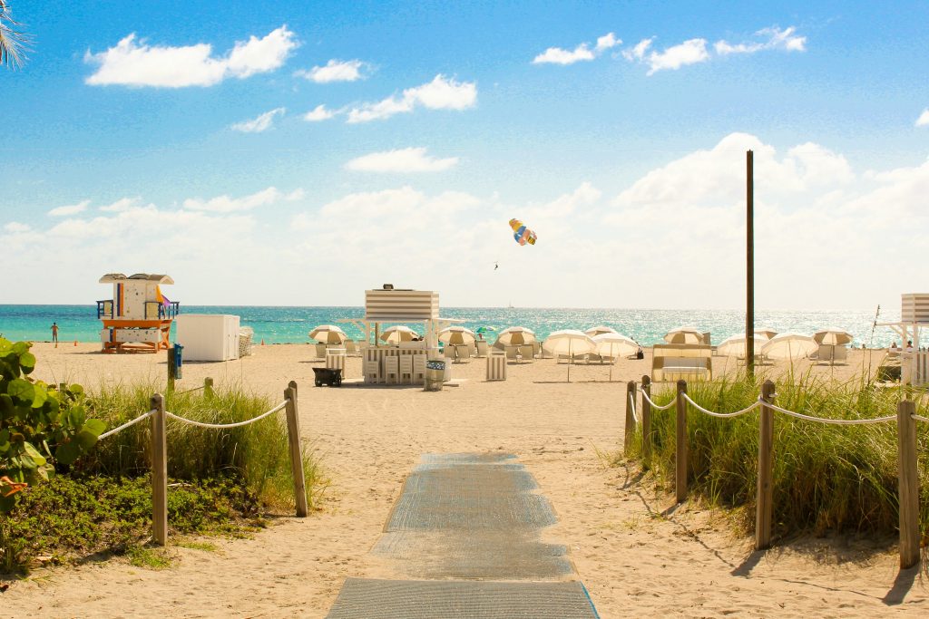 A boardwalk path through the dunes to the beach and the lifeguard stand
