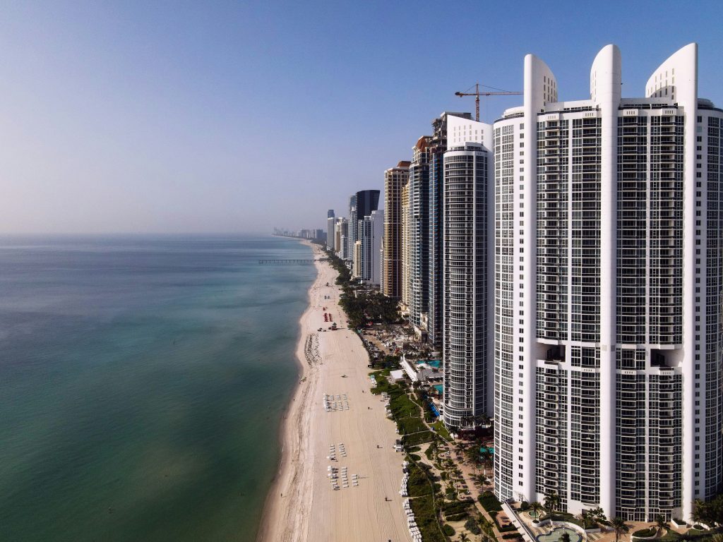 A wall of condominium towers running down the beach